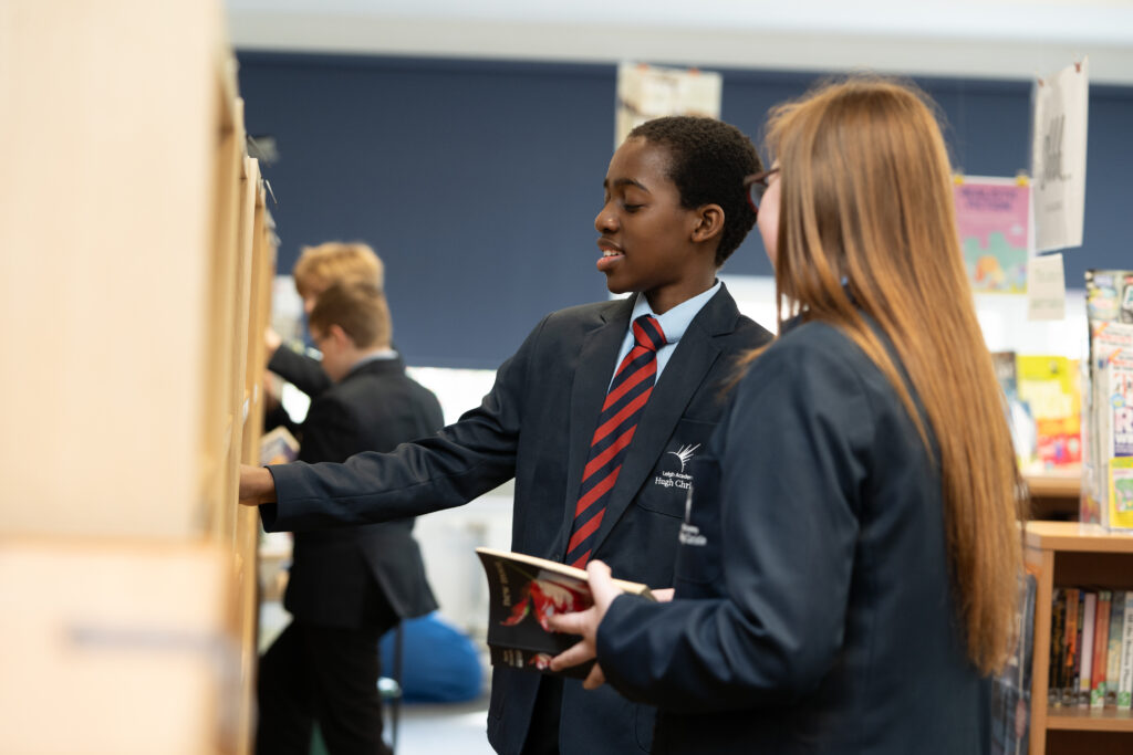 Students browsing books in the library at Leigh Academy Hugh Christie
